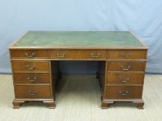 A twin pedestal mahogany desk with leather inset top and fitted with nine drawers,