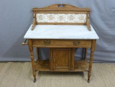 A marble topped satin walnut wash stand with tiled back,