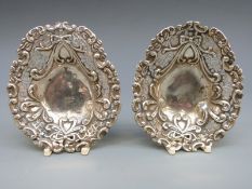 A Victorian pair of hallmarked silver pierced bon bon dish, raised on three ball feet,