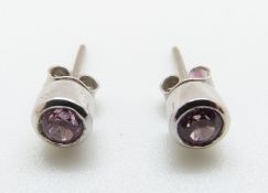 A pair of 18ct white gold earrings set with pink sapphire to each