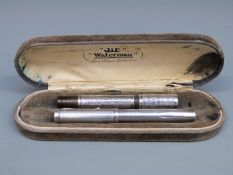 Two white metal cased fountain pens, one stamped Unic Depose and Mecan, the nib marked Swan 2 18ct,