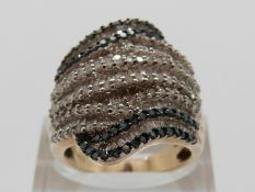 A 9ct gold ring set with round & baguette cut diamonds in a large banded design, size P, 10.