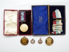 Two 9ct gold Masonic jewels and three Masonic jewels/medals with gold or silver mounts, one 9ct,