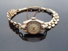Rone 9ct gold ladies wristwatch with gold hands and Arabic numerals,