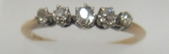 An 18ct gold ring set with five diamonds, 1.