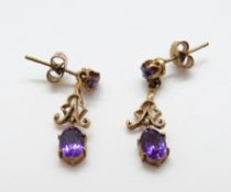 A pair or 9ct gold earrings set with amethysts