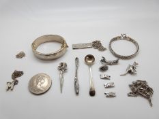 A collection of silver jewellery to include bracelet, ingot, brooch, chains,