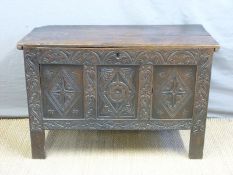 An 18thC carved oak three panel chest or coffer with candle box inside,