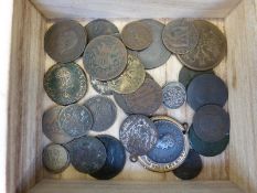 A small wooden cabinet containing ancient coins including Roman,