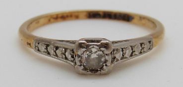 An 18ct gold ring set with a diamond in a platinum setting, 2.