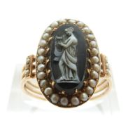 An early Victorian ring set with a hardstone cameo depicting a woman playing the harp,