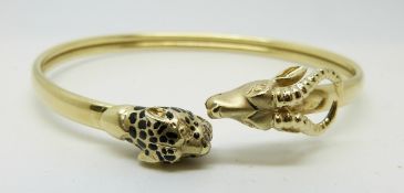 A 14ct gold bangle depicting a leopard and antelope, 14.