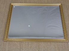 A gilt framed mirror with bevelled edge,
