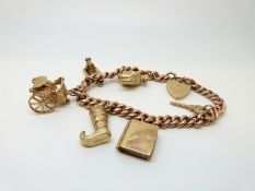 A 9ct rose gold curb link bracelet with six 9ct gold charms and heart padlock, 41.