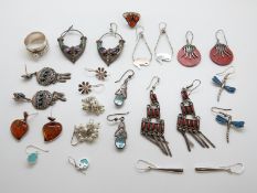 A collection of silver earrings including coral, turquoise,
