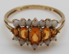 A 9ct gold ring set with citrines and opals, size T, 2.