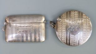 A hallmarked circular silver vesta with engine turned decoration,