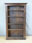 A stained pine bookcase with adjustable shelves,