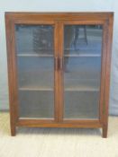 An oak bookcase with glazed doors,