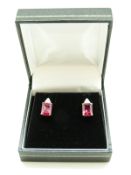 A pair of 9ct gold earrings set with a synthetic ruby and diamonds to each