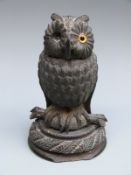 A 19thC carved bog oak owl ink well,