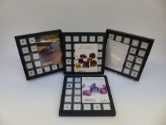 Four trays of loose gemstones including garnets, tourmaline, aquamarine, peridot, quartz, moonstone,