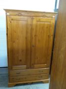 A pine wardrobe with two drawers to base,
