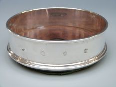 A feature hallmarked silver wine coaster, London 1986,