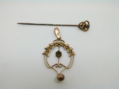 A 9ct gold Edwardian pendant and a 9ct gold pin set with a sapphire