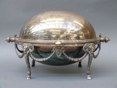 A plated warming dish with neoclassical swag decoration