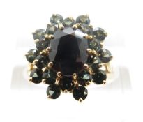 A 9ct gold ring set with an oval sapphire surrounded by tourmaline, size N/O, 4.
