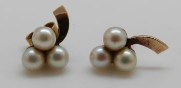 A pair of 9ct gold earrings set with three pearls to each and a gold brooch set with pearls