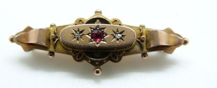 A 9ct gold Victorian brooch set with a red paste and diamonds, glass compartment verso, 2.