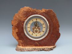 Rustic cased burr walnut mantel clock fitted with battery driven visible movement,