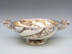A Victorian hallmarked silver wrythen lobed bowl with twin figural handles,