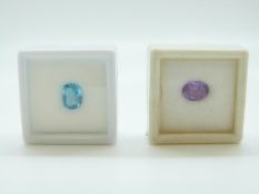 A blue mixed cut topaz and an oval cut amethyst