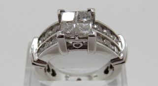 A 14k white gold ring set with four princess cut diamonds, each approximately 0.
