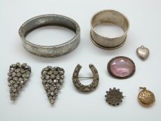 A hallmarked silver bangle, silver napkin ring, pair of Victorian clips set with foiled paste,