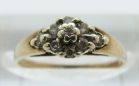 A 9ct gold ring set with diamonds in a cluster, size J, 1.