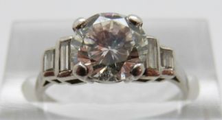 A platinum Art Deco ring set with a round brilliant diamond measuring approximately 1.