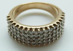 A 9ct gold ring set with diamonds in four rows, size O, 7.