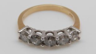 An 18ct gold ring set with five diamonds, the centre diamond approximately 0.