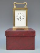 A French style mid to late 20thC brass carriage clock with reeded decoration to square corners.