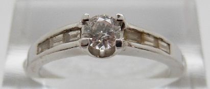An 18ct white gold ring set with a round cut diamond of approximately 0.