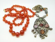 A graduated beaded carnelian agate necklace and a white metal necklace set with rose quartz,