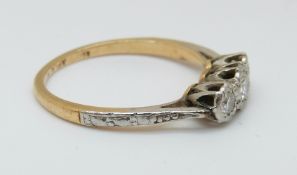 An 18ct gold ring set with three diamonds in a platinum setting, 2.