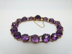 A 9ct gold Victorian bracelet set with graduated purple paste stones
