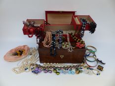 A leather jewellery box and rosewood box containing costume jewellery including Miracle brooch,