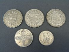 Three half crowns, 1923, 1926 and 1935, together with a 1923 florin and a 1925 shilling,