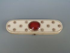 A Georgian ivory lidded pot set with rose gold raised studs and a carnelian agate cabochon,